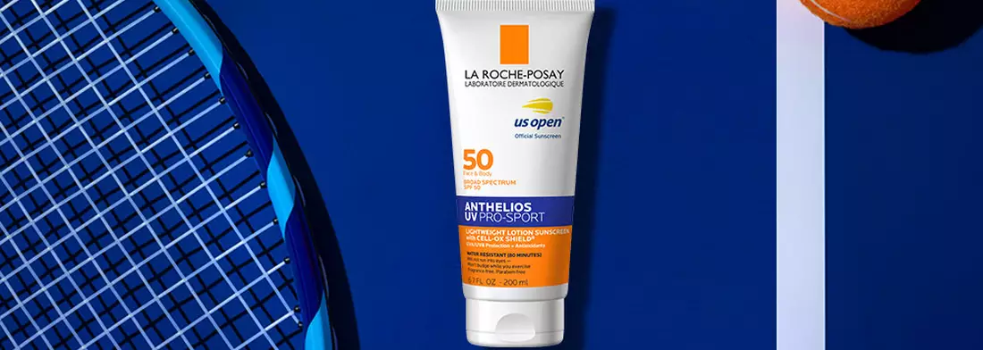 Anthelios UV Pro Sport Bottle on Tennis Court with racket and orange tennis balls